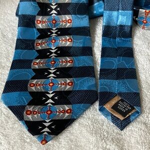 Emilio Sandrini  Blue Tie with Bullseye Design. 100% Polyester. 4” wide, 58”.